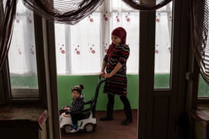 Aired Arizona plays with her son in Sary-Mogol.