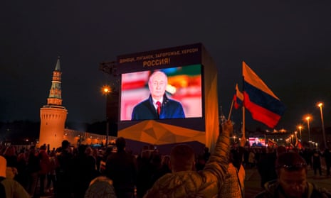 State TV broadcasting in Moscow square with image of Putin