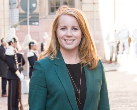 Annie Lööf outdoors, smiling, wearing a green suit