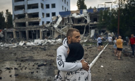 A couple reacts after the Russian shelling in Mykolaiv, Ukraine, Wednesday, Aug. 3, 2022. According local media, supermarket, high-rise buildings and pharmacy were damaged. (AP Photo/Kostiantyn Liberov)