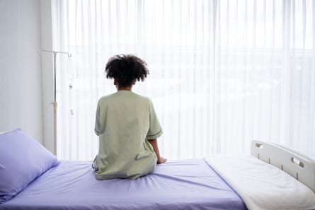 Lonely patient sitting on a hospital bed