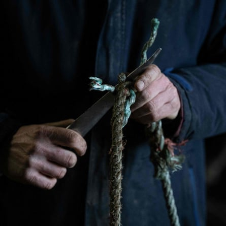 Skipper James Cole repairs lobster pots