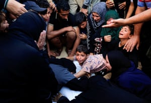 Mourners react at a funeral gathering