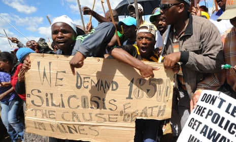 Striking miners demand compensation as they march to the offices of AngloGold Ashanti in the gold-mining town of Carletonville in October 2012