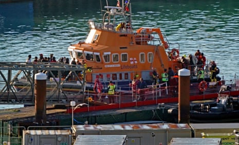People thought to be asylum seekers arriving at Dover on the Dover lifeboat after being picked up in the Channel earlier today.