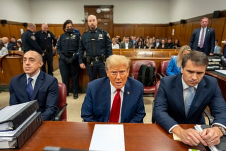 Donald Trump appears in court with his attorneys Emil Bove, left, and Todd Blanche during his trial on 25 April in New York City.