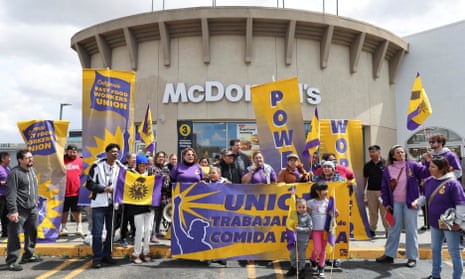 California fast-food workers hold a rally as they celebrate their minimum wage increase in Los Angeles, on 5 April.