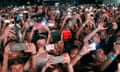 Crowd of people taking photos with the phone in a summer concert