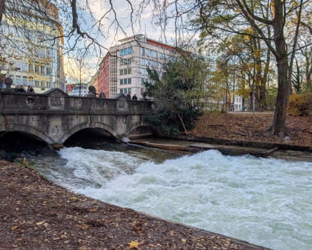 People look at the spot where there once was the Eisbach wave