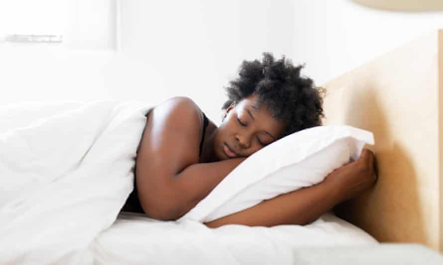 African woman sleeping in bed at home Young woman sleeping in bed in the morning at home.
