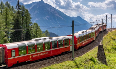 The Bernina Express in Graubünden,  Switzerland, with mountains behind