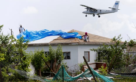 Devon Warner and his daughter Che Niesha work on the roof of a home at Codrington on the island of Barbuda just a month after Hurricane Irma struck in early October.