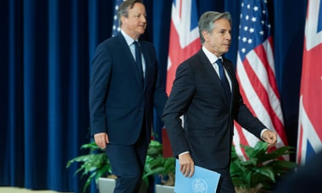 Secretary of State Antony Blinken, right, and British Foreign Secretary David Cameron walk out of the room following a meeting at the State Department a little earlier today.