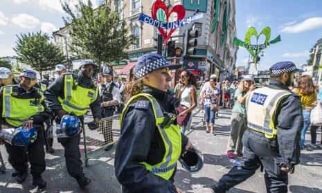 Riot police pass by the Grenfell quiet area after the minute’s silence at the Notting Hill carnival last year.