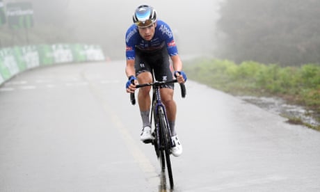 Jay Vine braves deluge to win Vuelta stage six as Evenepoel grabs red jersey