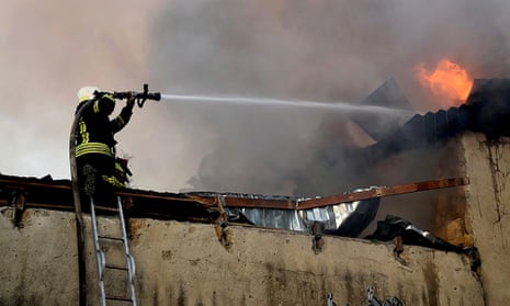 A firefighter battles a blaze after shelling in Mykolaiv