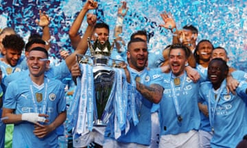 Manchester City’s Kyle Walker lifts the Premier League trophy after the final-day 3-1 victory over West Ham.