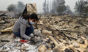 A woman searches for belongings in the ashes of her home in Santa Rosa, California.