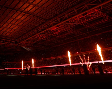 Pyrotechnics greet the teams as they make their way onto the pitch.