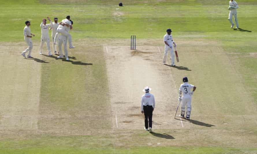 England’s Ollie Robinson is held aloft by a teammate after dismissing Virat Kohli.