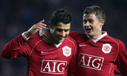 Cristiano Ronaldo celebrates with Ole Gunnar Solskjaer after scoring a rebounded penalty against Wigan in 2006.