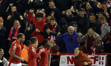 Nottingham Forest’s Emmanuel Dennis celebrates scoring their first goal with team-mates in front of the ecstatic Forest fans.