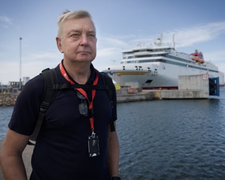Per Wikberg stood on a dock with a ferry in the background