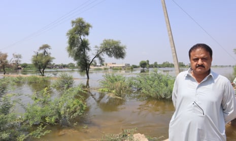 Mohammed Ali, a landlord in Sohbatpur, standing in front of his flooded agricultural land.