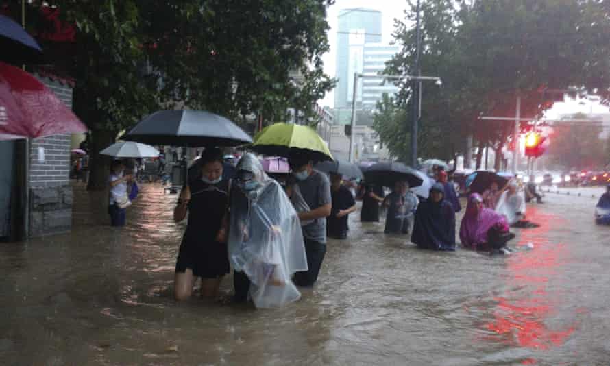 People caught in flood water in Zhengzhou city in China's Henan province.