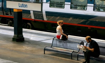 Commuters wait for their train on the platform at Luton train station