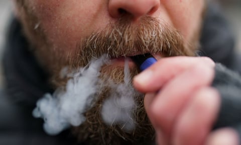 A man using a disposable vape