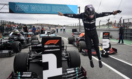 Lewis Hamilton of Britain jumps out of his car after his record-breaking win.