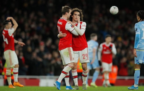 Arsenal’s Rob Holding and Matteo Guendouzi embrace at full time.