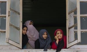 Women look out of a window in Srinagar, Kashmir