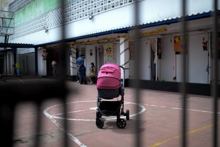 A pram in a prison setting behind bars