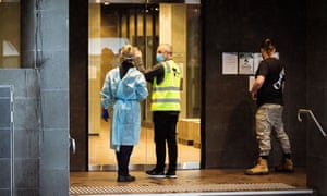 Department of Health and Human Services staff prepare to enter a Tier 2 exposure site at a Brunswick apartment in Melbourne.