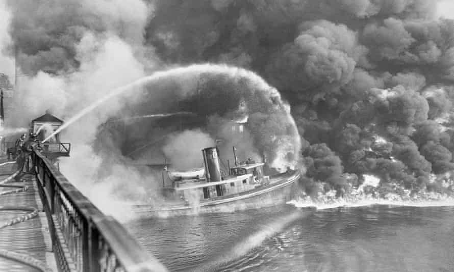 Firefighters deal with a burning oil spill on the Cuyahoga River in 1952.