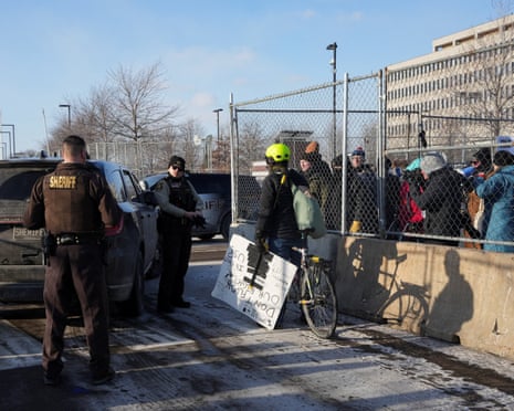 Demonstrators gather outside the Bishop Henry Whipple federal building