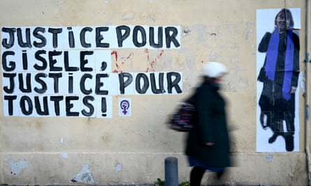 A pedestrian walks past a mural