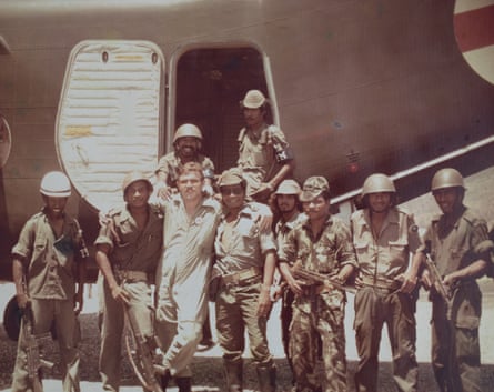 Copypix - Keirman French with Fretilin fighters at Dili airport, 1975. Photo, Pilot Officer, Gordon Browne. In 1975, during a civil war in East Timor, armed soldiers forced their way onto a Caribou plane and demanded that women and children be taken to Australia. About 50 people were flown on the plane, which was only able to normally carry 32 passengers. Keirman French, the pilot, remembers being threatened at gunpoint by one of the soldiers.