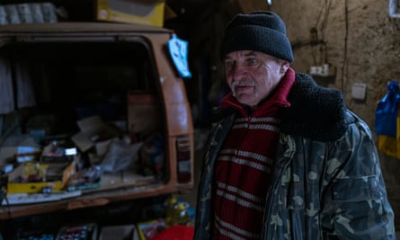 Oleksandr Shekavcuk in the city's only shop, which he and his wife Valentyna run in their garage.