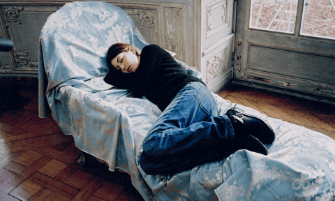 Sofia Coppola sleeping on a chaise longue on the set of Marie Antionette.