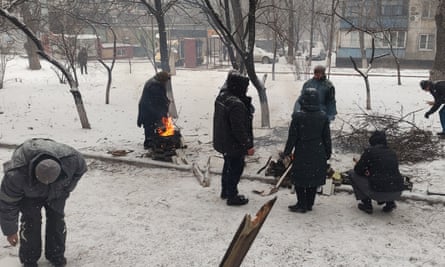 Residents cook food on fires outside their flats in March 2022.