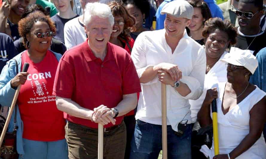 Brad Pitt and Bill Clinton, with about 600 volunteers, help clean Lower Ninth Ward on 16 March 2008.