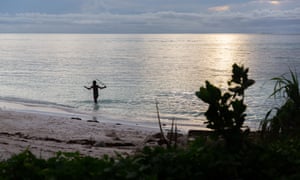 A young boy plays in the shallows of the Funafuti lagoon on Tuvalu in March, 2019.