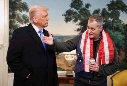 Trump stands beside Fogel, who is wearing a US flag around his neck