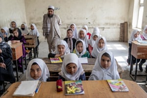 Girls attend class on the first day of the new school year in Kabul