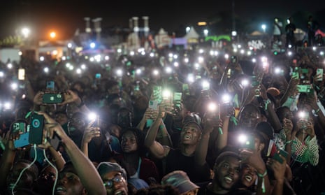 Young people holding up their phones in Accra