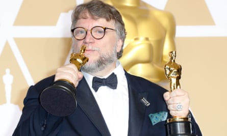 Mexican wave … Del Toro celebrates his double win for The Shape of Water at the 2018 Oscars.
