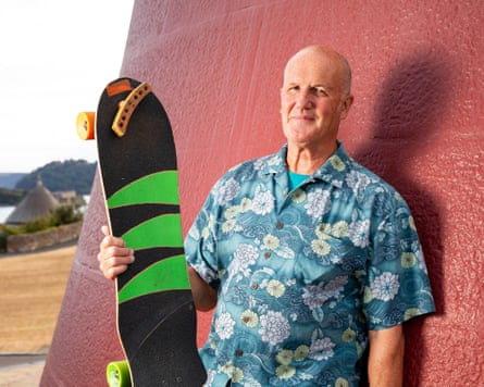 Miles holding a green and black skateboard